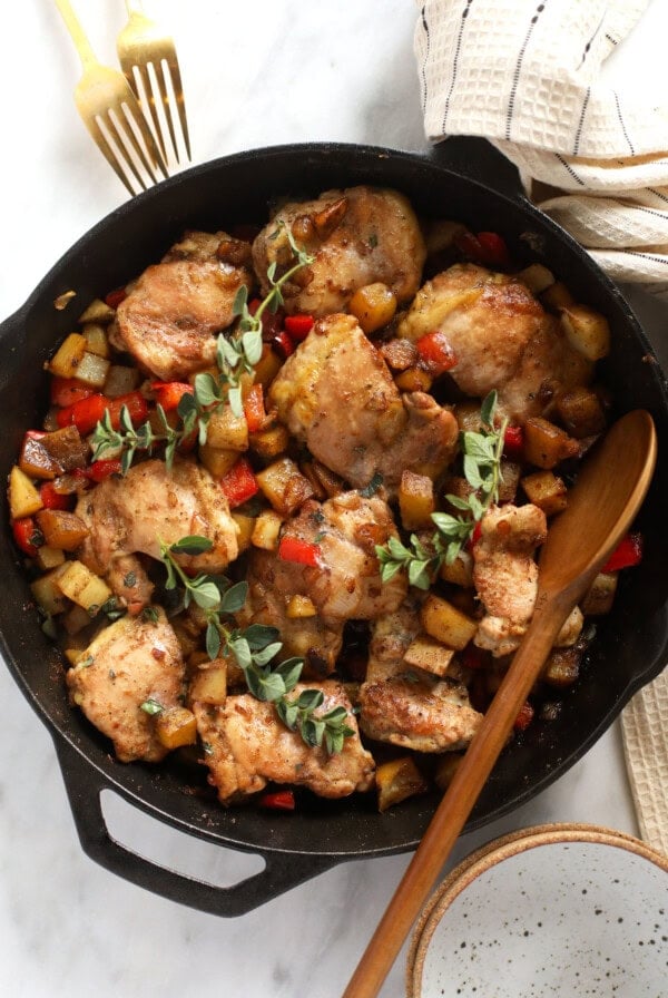 skillet chicken and potatoes in a cast iron skillet
