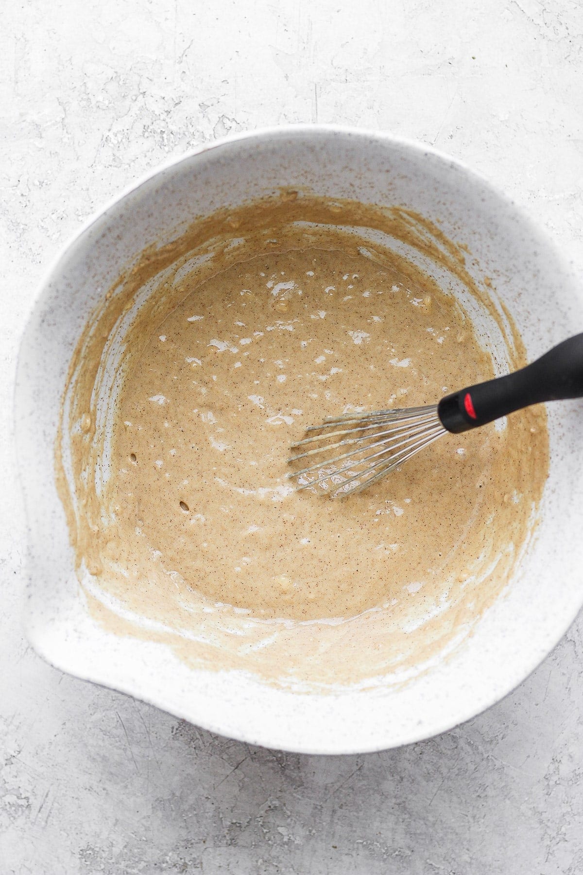 all the ingredients for cinnamon roll waffles mixed together in a bowl