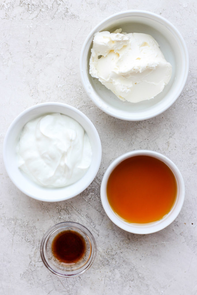 Cream cheese frosting ingredients in bowls.