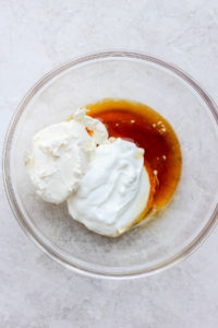 All of the ingredients for cream cheese frosting in a bowl.