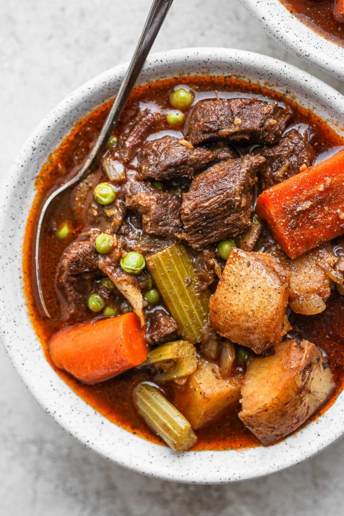instant pot beef stew in a bowl with a spoon