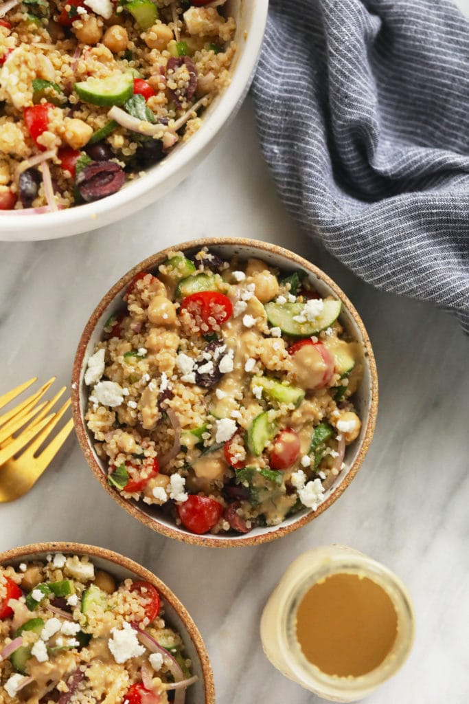 2 bowls of quinoa salad with dressing.