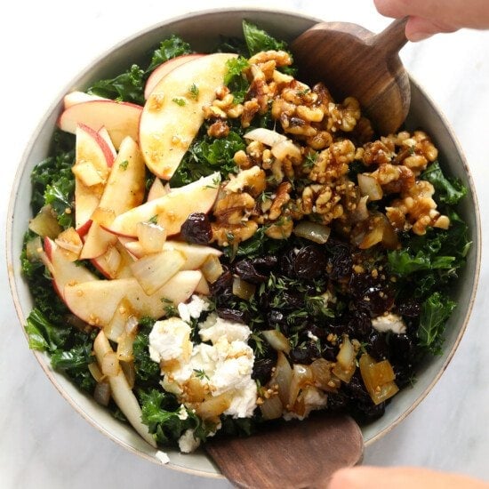 A Thanksgiving salad featuring kale, apples, and walnuts.