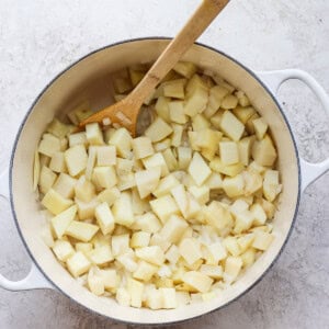 Potatoes and onion in a pot.