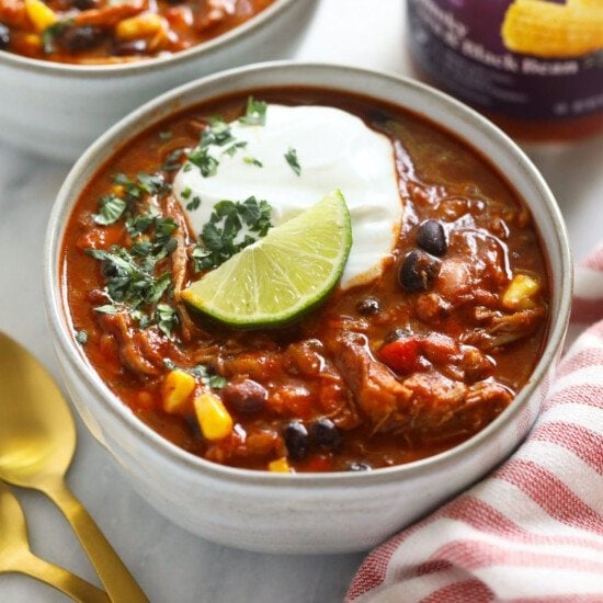 two bowls of pork chili with sour cream.