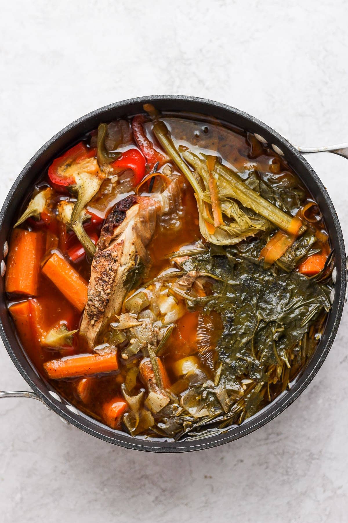 A pot of chicken and vegetables after simmering all day. 