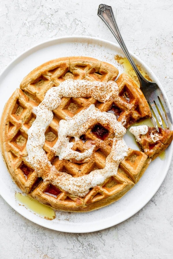 cinnamon roll waffle on a plate with a delicious drizzle