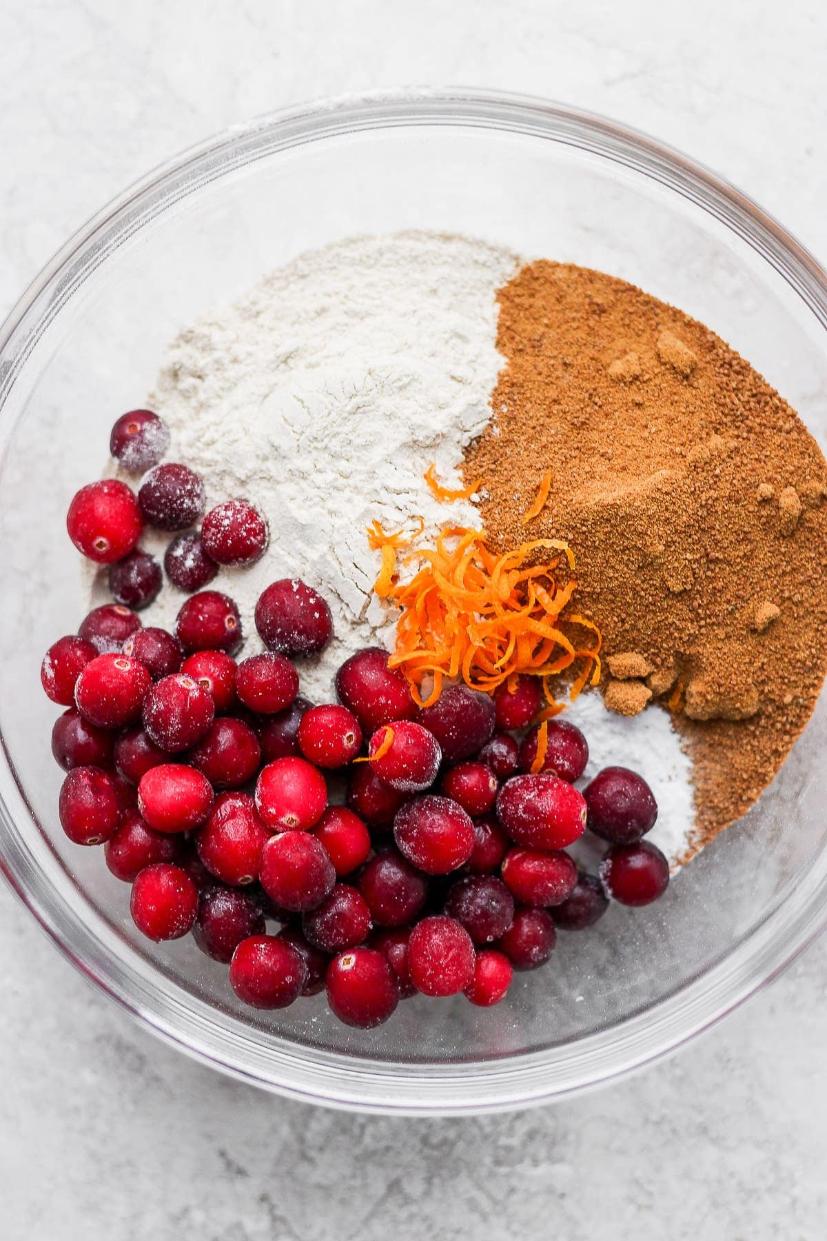 ingredients for cranberry orange muffins on a bowl, ready to be mixed