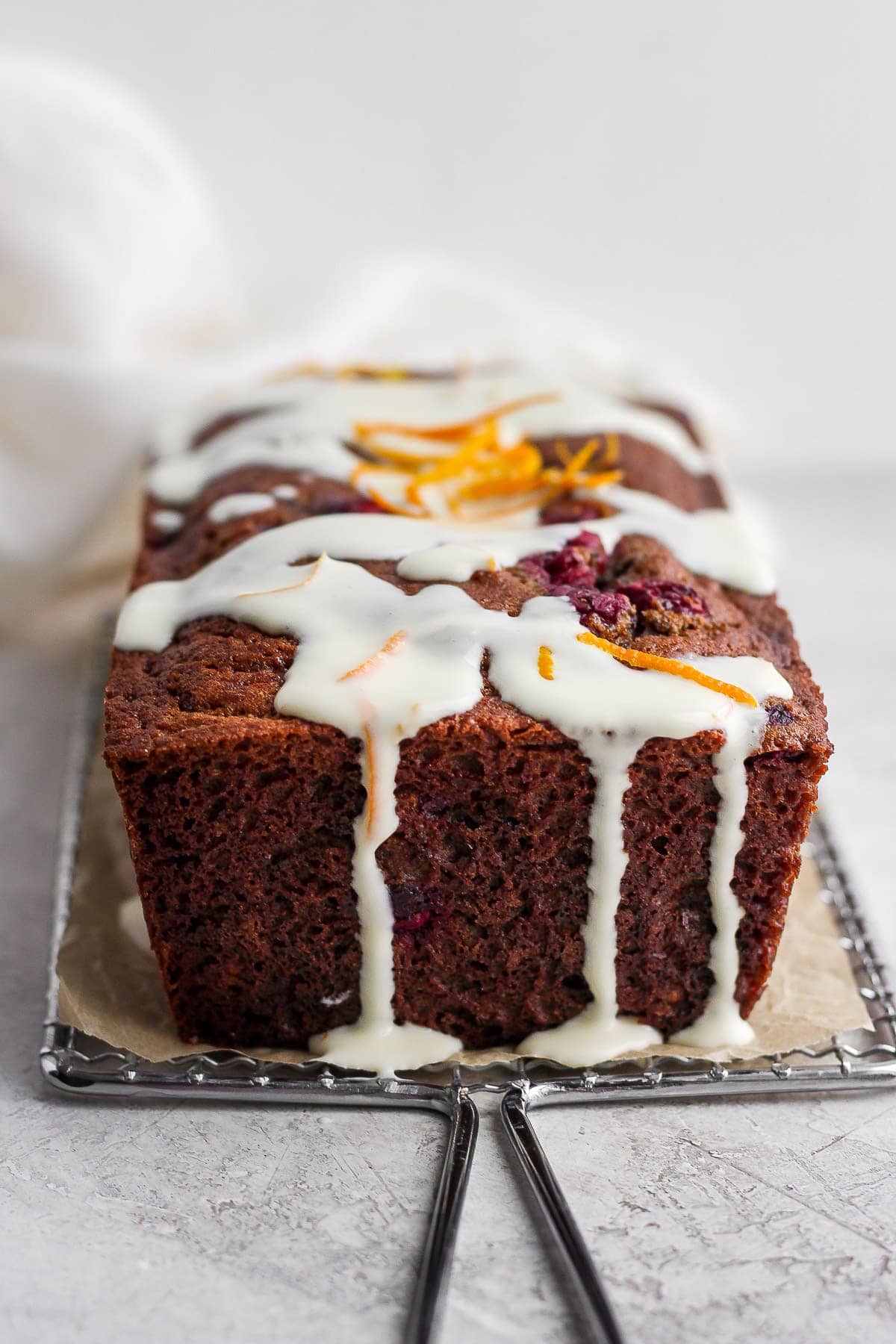 cranberry orange bread with a cream cheese glaze