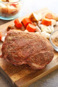 A delicious Instant Pot pork roast with vegetables, beautifully displayed on a cutting board.