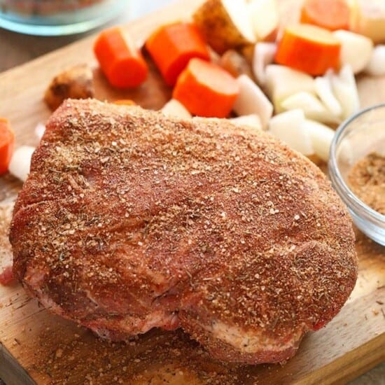 A delicious Instant Pot pork roast with vegetables, beautifully displayed on a cutting board.