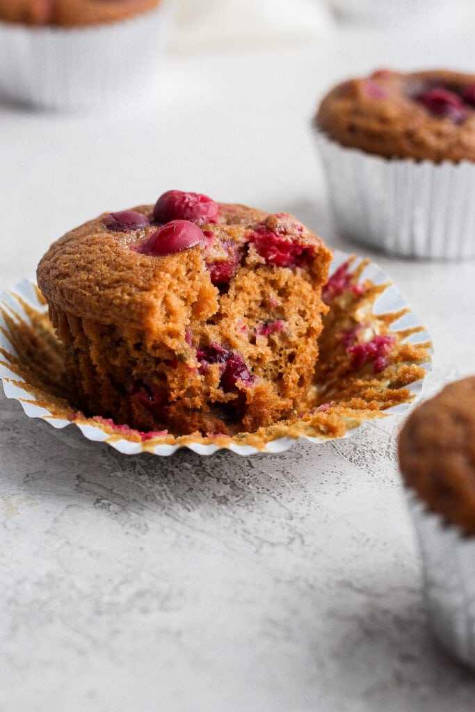 cranberry orange muffin with a bite taken out of it