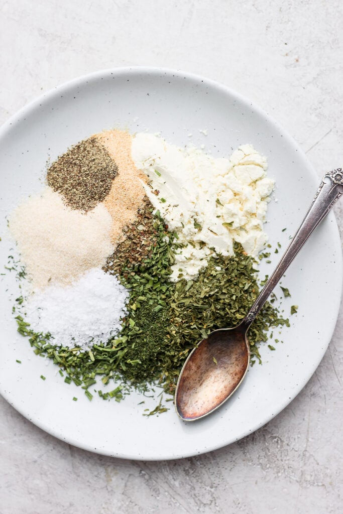 The best homemade ranch spice recipe on the web. You'll want a jar of this ranching condiment on top of any store-bought pack...trust me! Ranch spices on a plate.