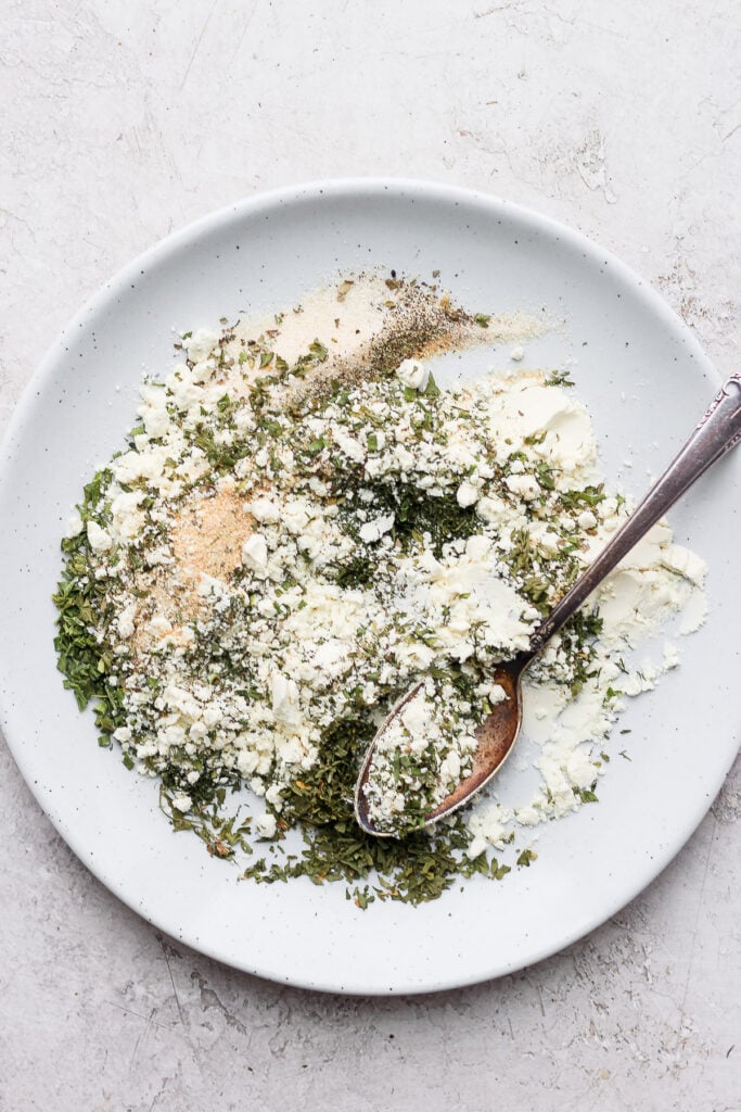 The best homemade ranch spice recipe on the web. You'll want a jar of this ranching condiment on top of any store-bought pack...trust me! Ranch spices mixed on a plate.
