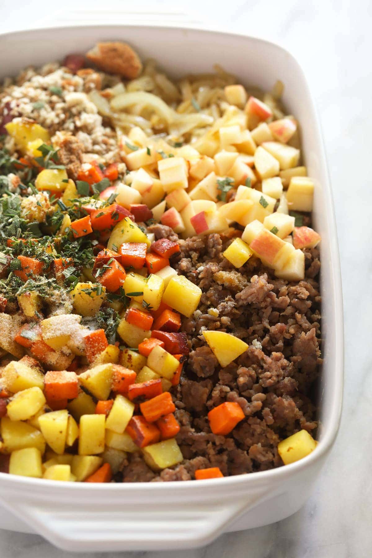 sausage stuffing ingredients ready to be mixed in a casserole dish