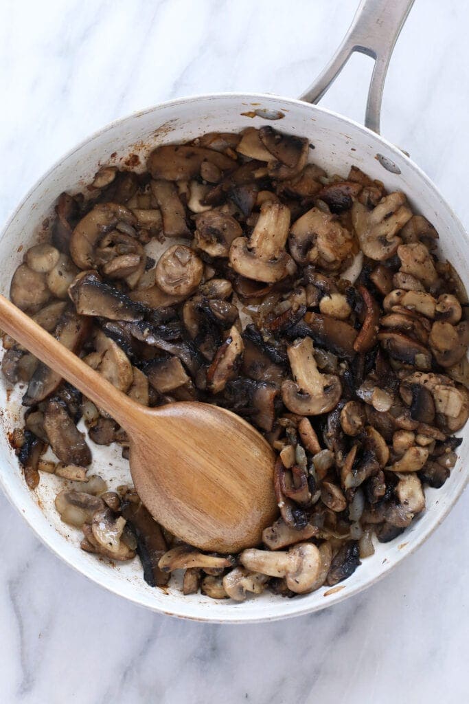 Sautéd mushrooms in a fry pan.