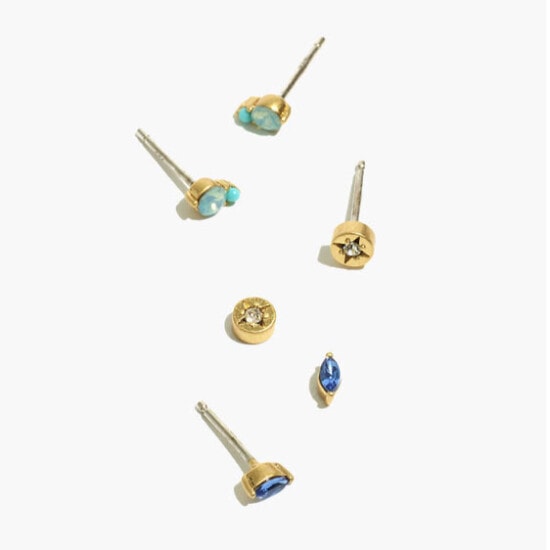 a set of gold stud earrings with blue stones.
