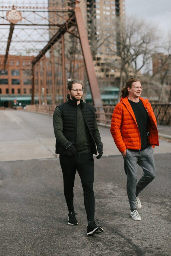 Fit foodie husbands walking across a bridge in lululemon gear.