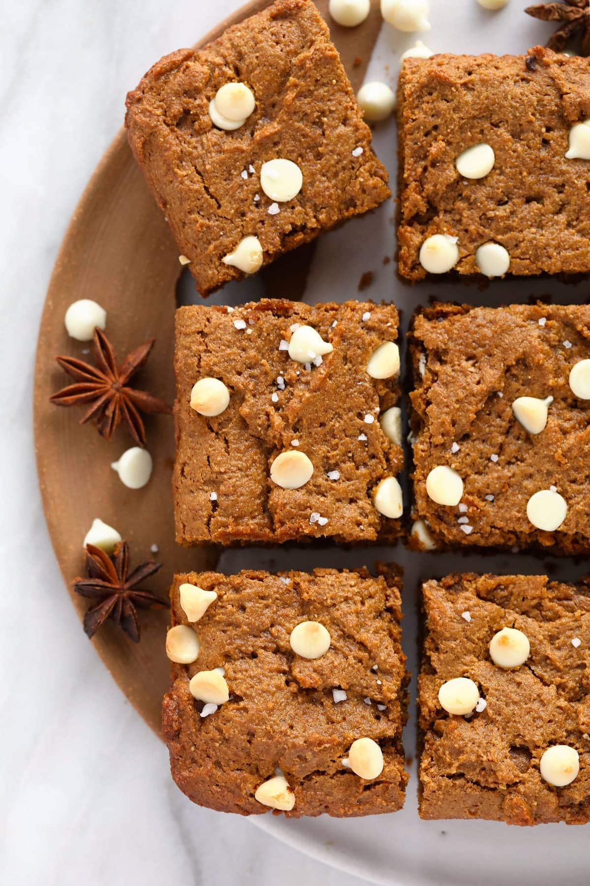 gingerbread cookie bars topped with white chocolate chips and sea salt