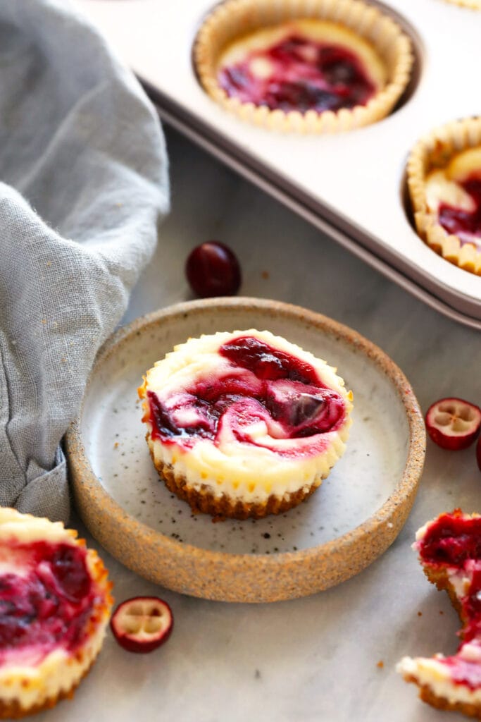 Cranberry cheesecake bites in a tin and on a plate. 