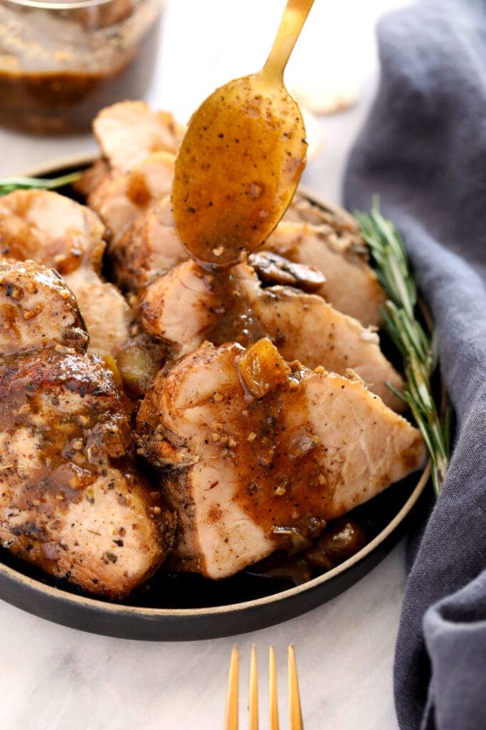 pouring sauce on pork tenderloin.