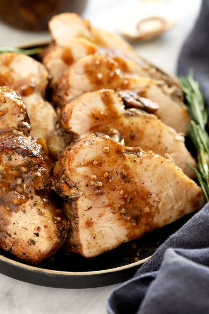 sliced pork tenderloin on plate.