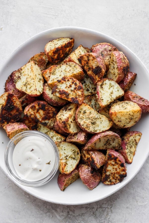 roasted red potatoes with a side of ranch dressing dipping sauce