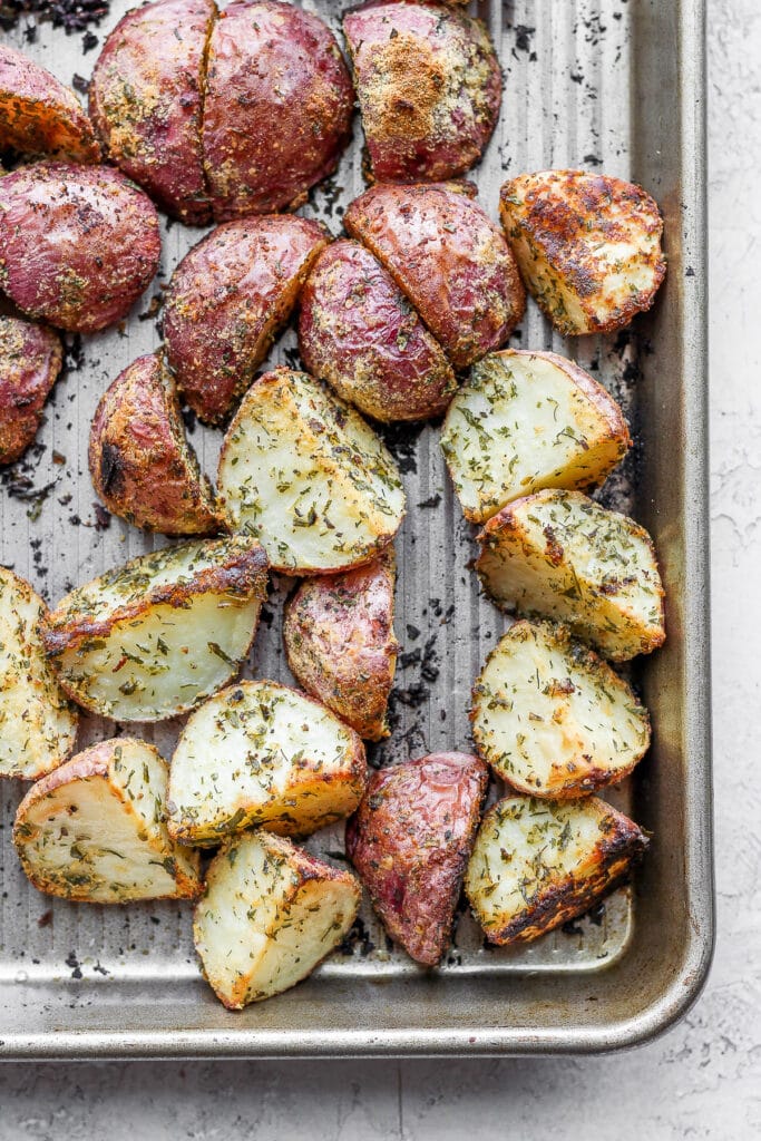 roasted red potatoes on a baking sheet looking crispy and delicious