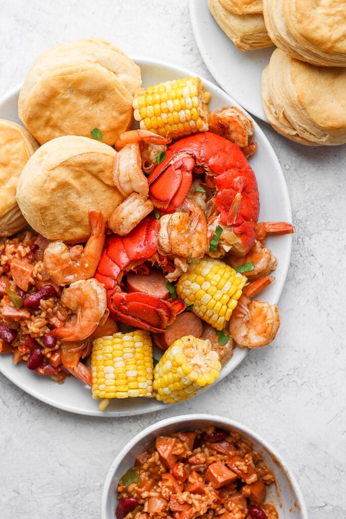 easy seafood boil on a plate with rice and beans and biscuits