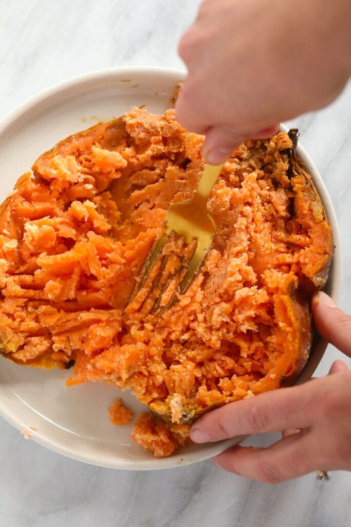 Making sweet potato puree out of a baked sweet potato.