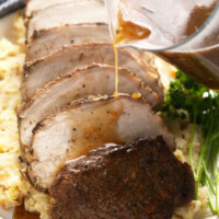 slow cooker pork ، sliced on a bed of mashed ،atoes.