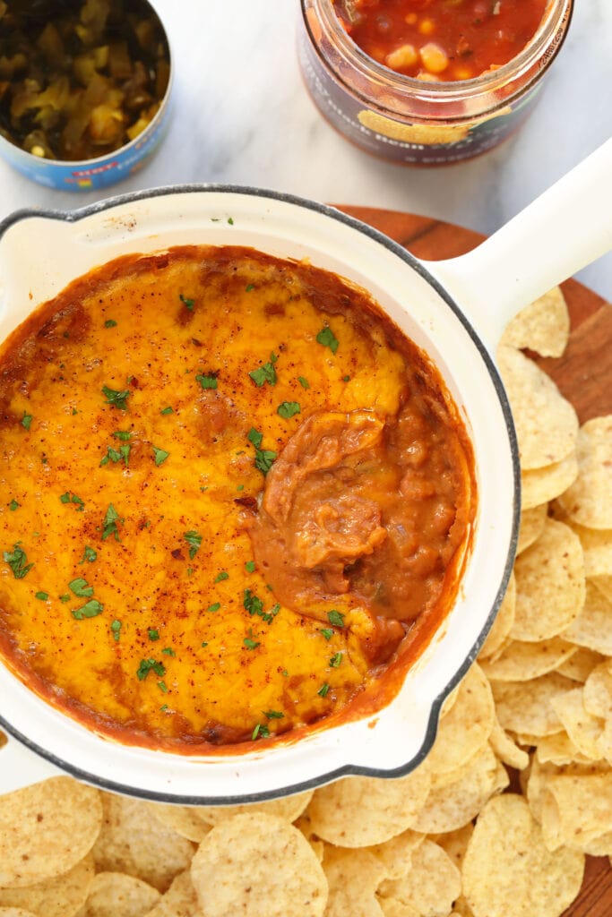 bean dip covered in melted cheese in a skillet