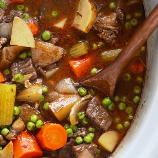 crock pot beef stew with carrots and peas.