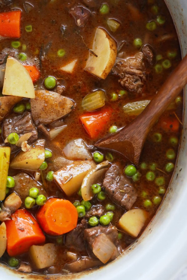 crock pot beef stew with carrots and peas.