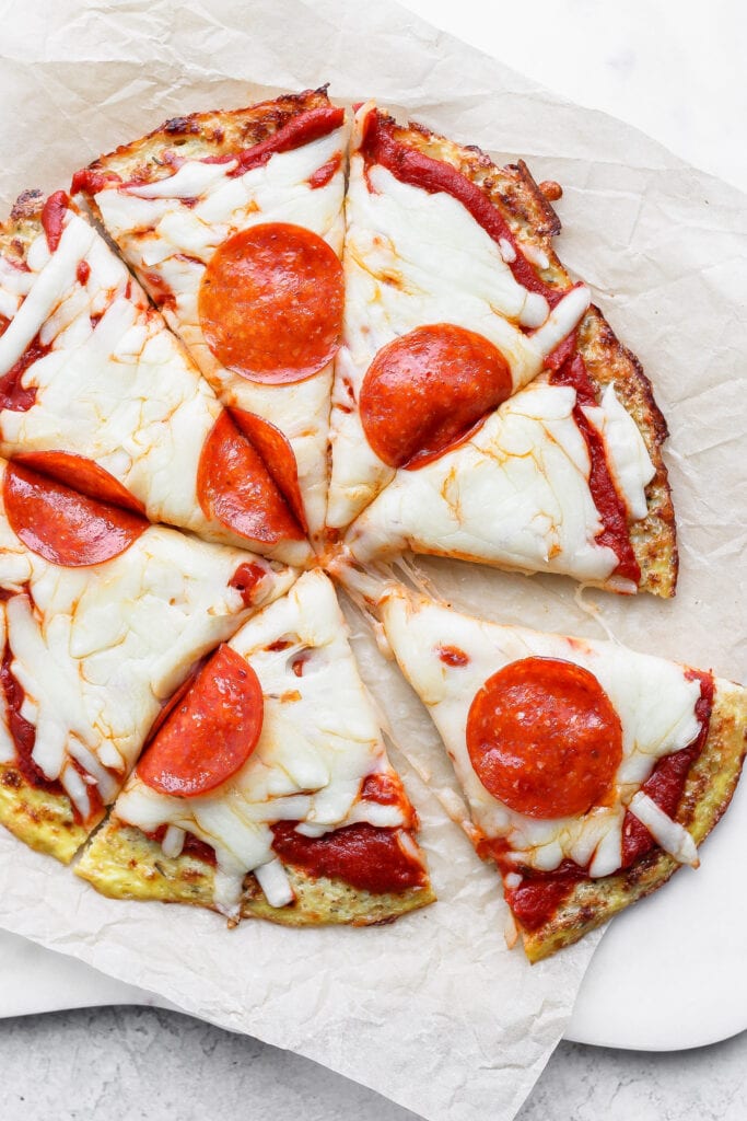 Cauliflower pizza with cheese and pepperoni on top. 