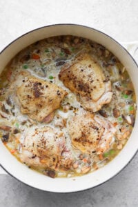 a pan with chicken and vegetables in it.