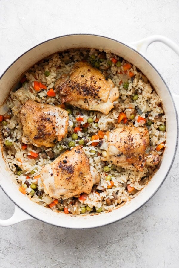 chicken and rice in a skillet on a white background.