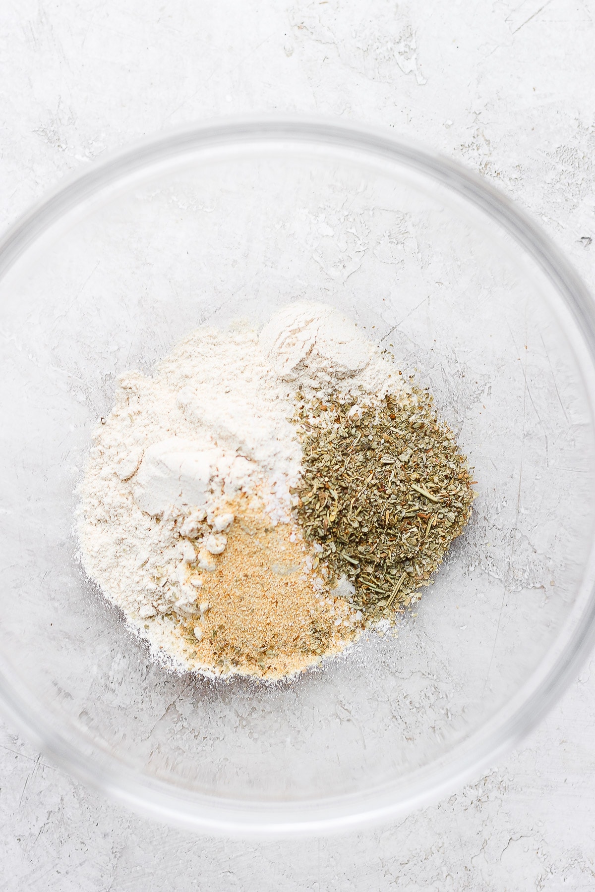 Flour and spices in a clear bowl. 