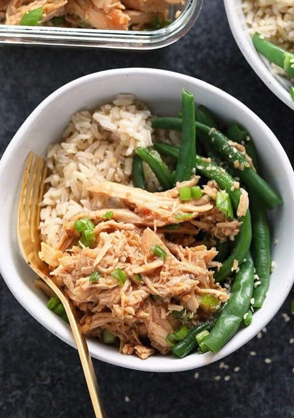 a bowl of honey garlic chicken with rice and green beans