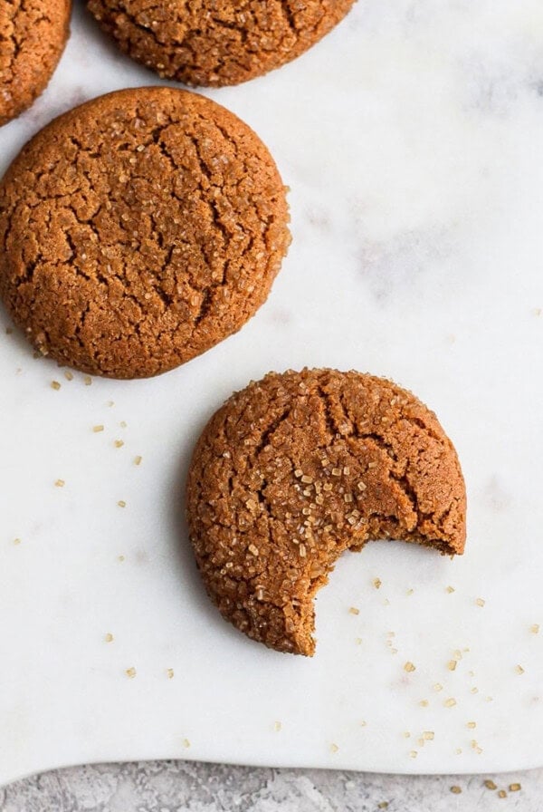 Gingersnap cookies with a bite taken out of them.