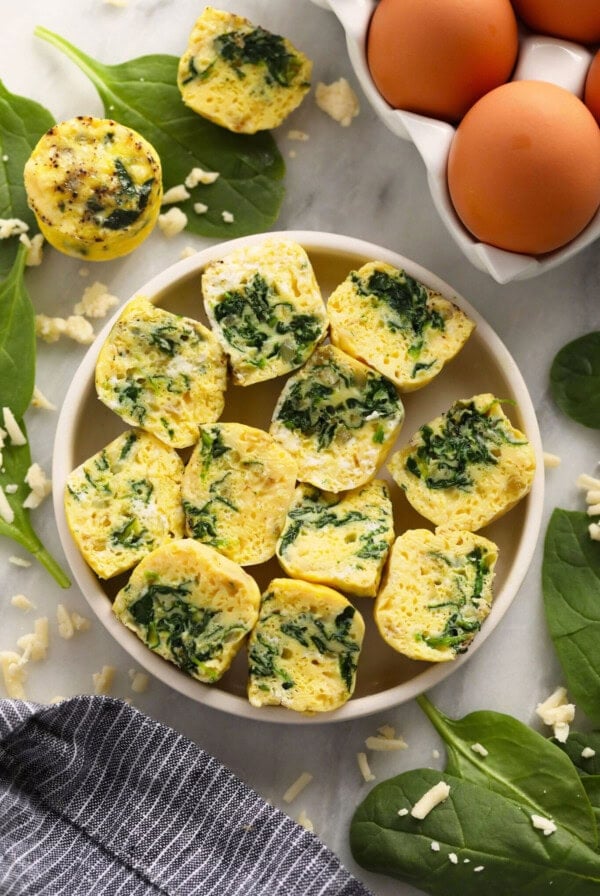 a plate with spinach and eggs on it.