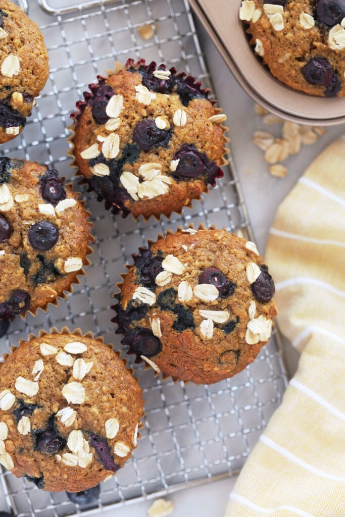 blueberry oatmeal muffins on a cooling rack looking delicious and fluffy
