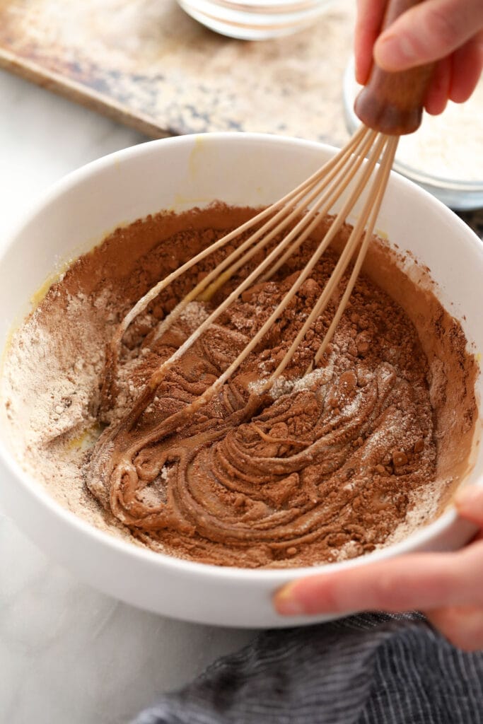 whisking together flour and cocoa powder