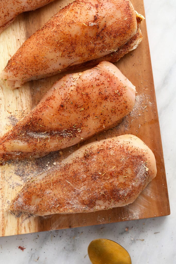 raw chicken breasts on a cutting board TeamJiX