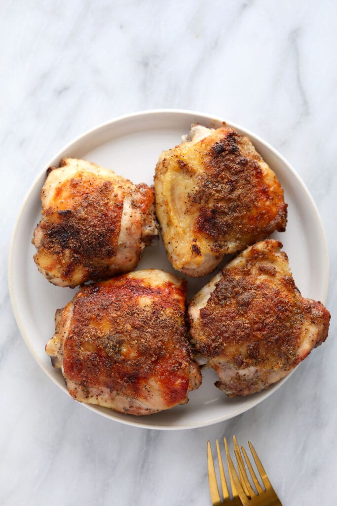 Baked chicken thighs on a plate. 