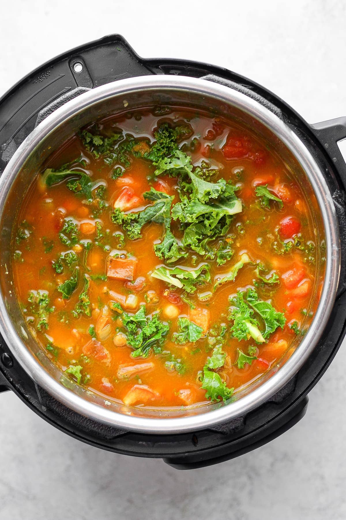 Instant Pot lentil soup with fresh kale on top. 