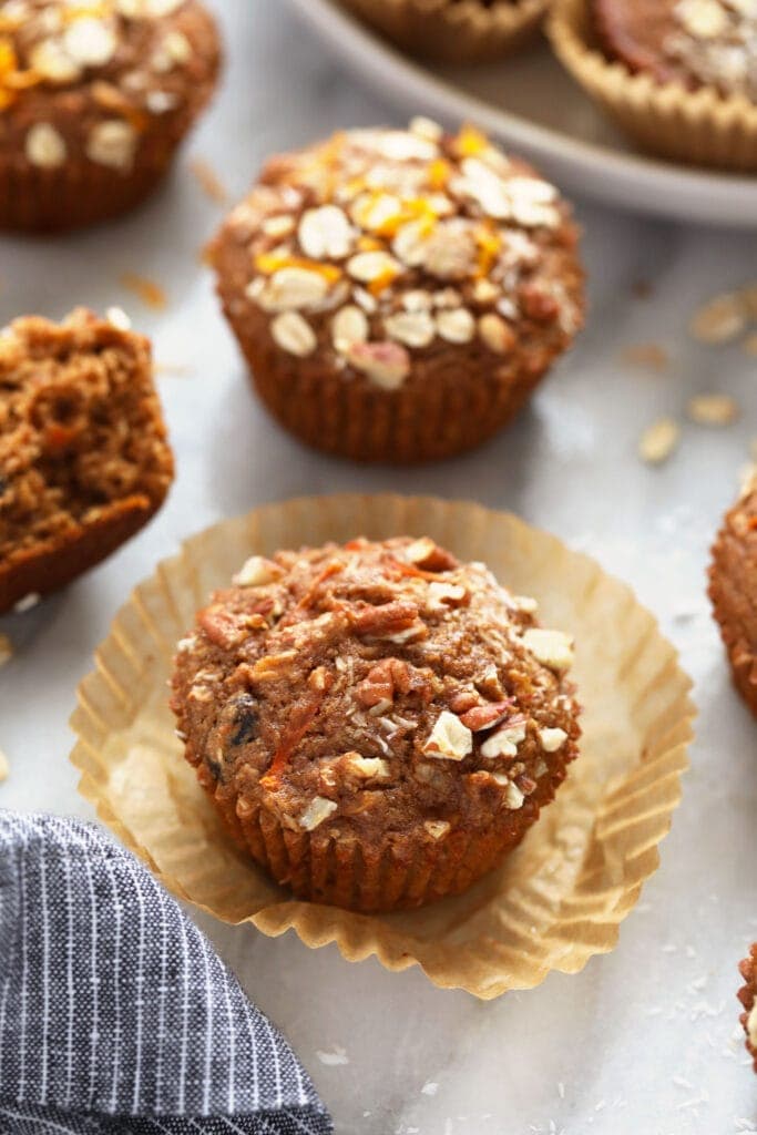A morning glory muffin with fresh oats on top. 