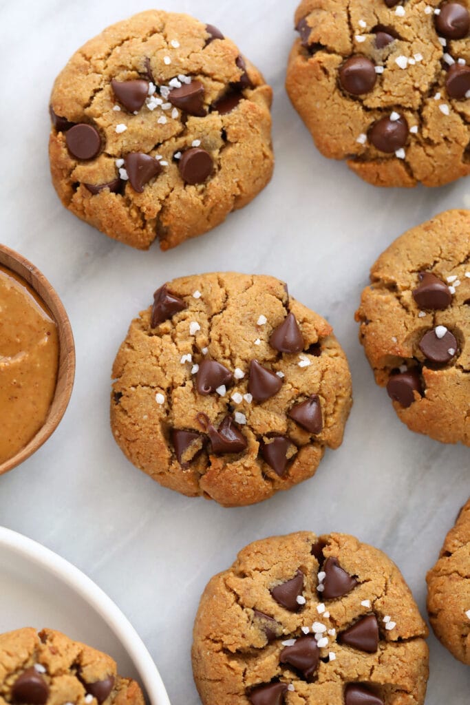 healthy peanut butter cookies topped with dark chocolate chips and coarse sea salt