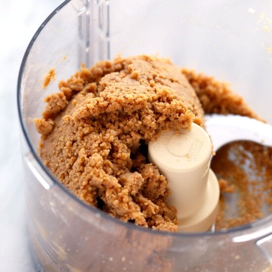 Making homemade peanut butter in a food processor to use as an ingredient for protein bars.