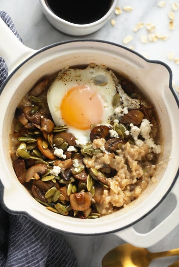 Savory oatmeal in a pot topped with a fried egg.